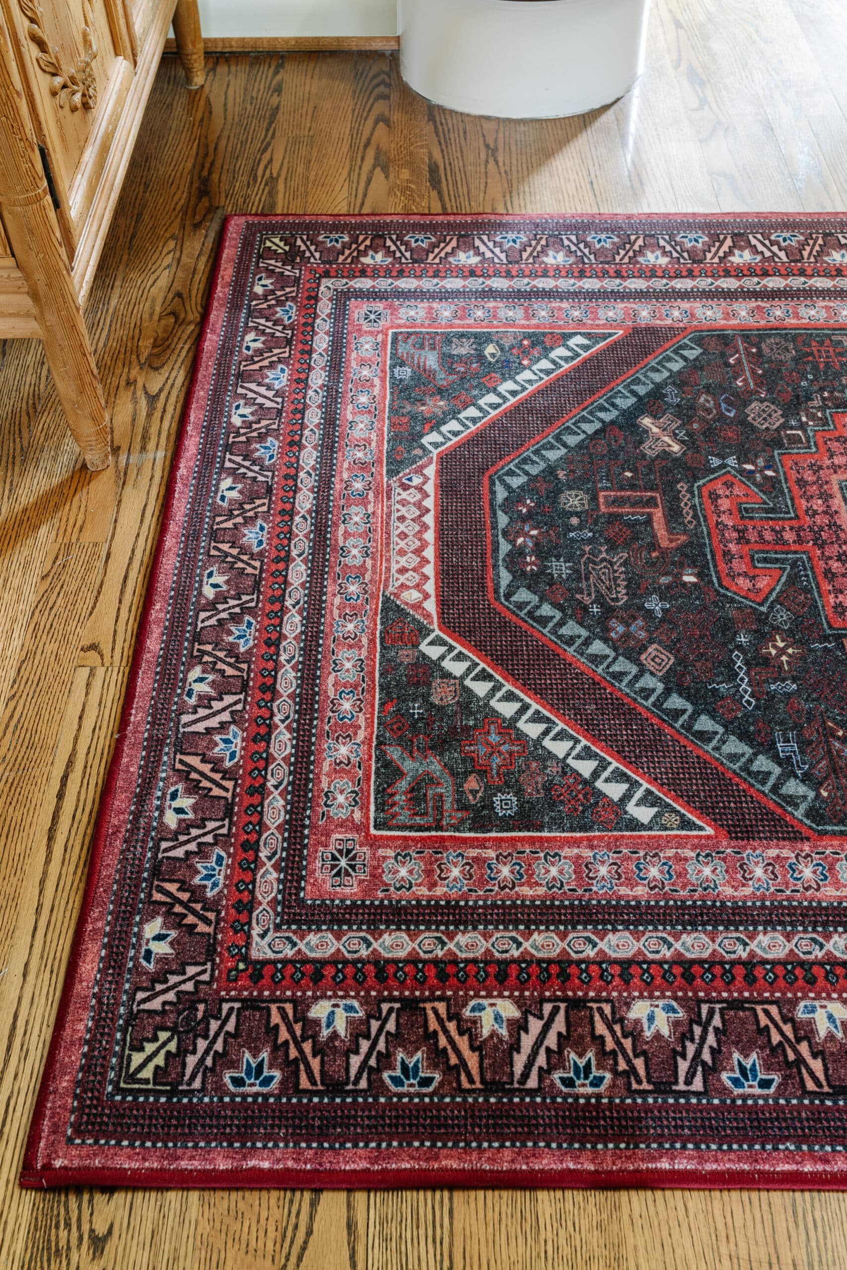 rug in a foyer on top of hardwood floors