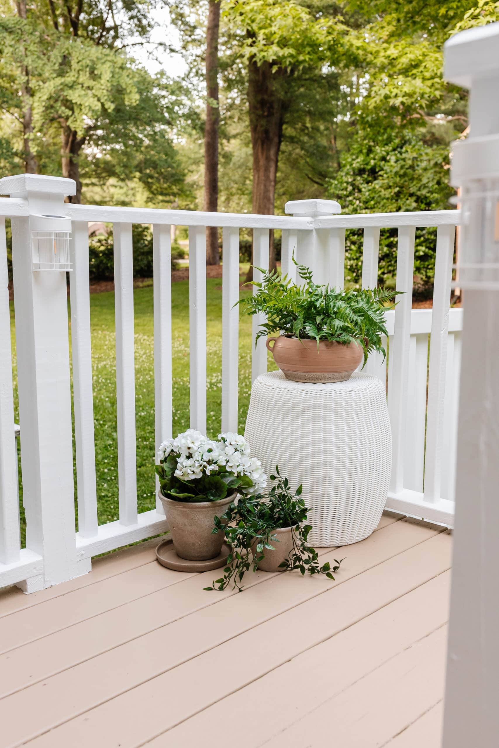 woven outdoor end table with planters on a deck
