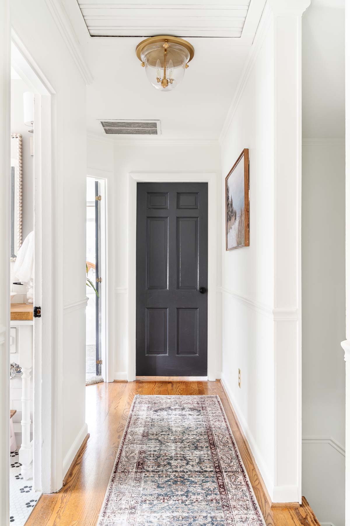 white hallway with black doors