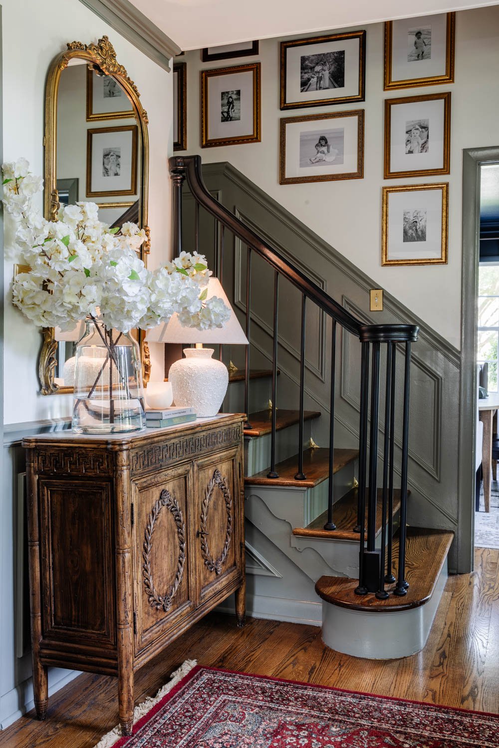 foyer stairs with dust corners and gallery wall