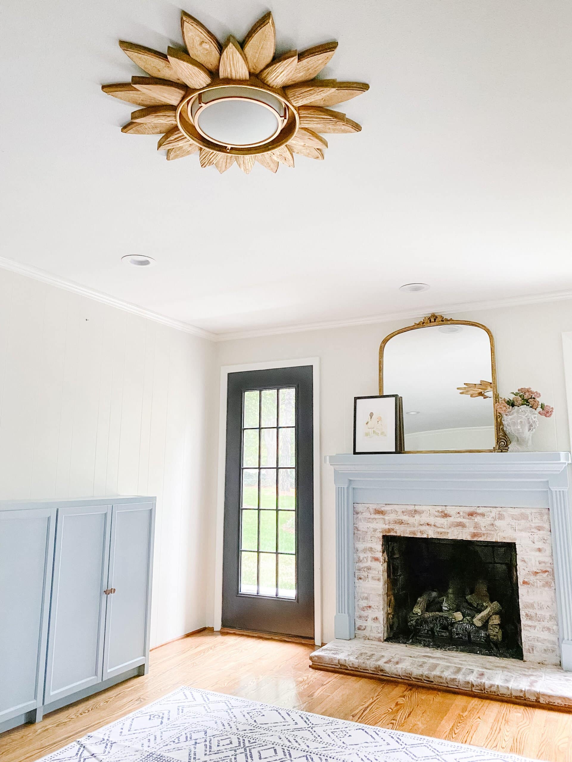 gold spray painted sunburst light in a playroom