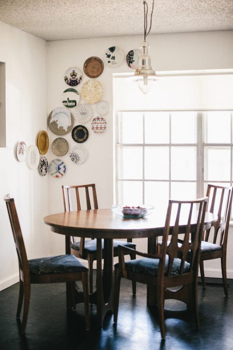 a corner plate gallery wall in a dining room as thrifty DIY art