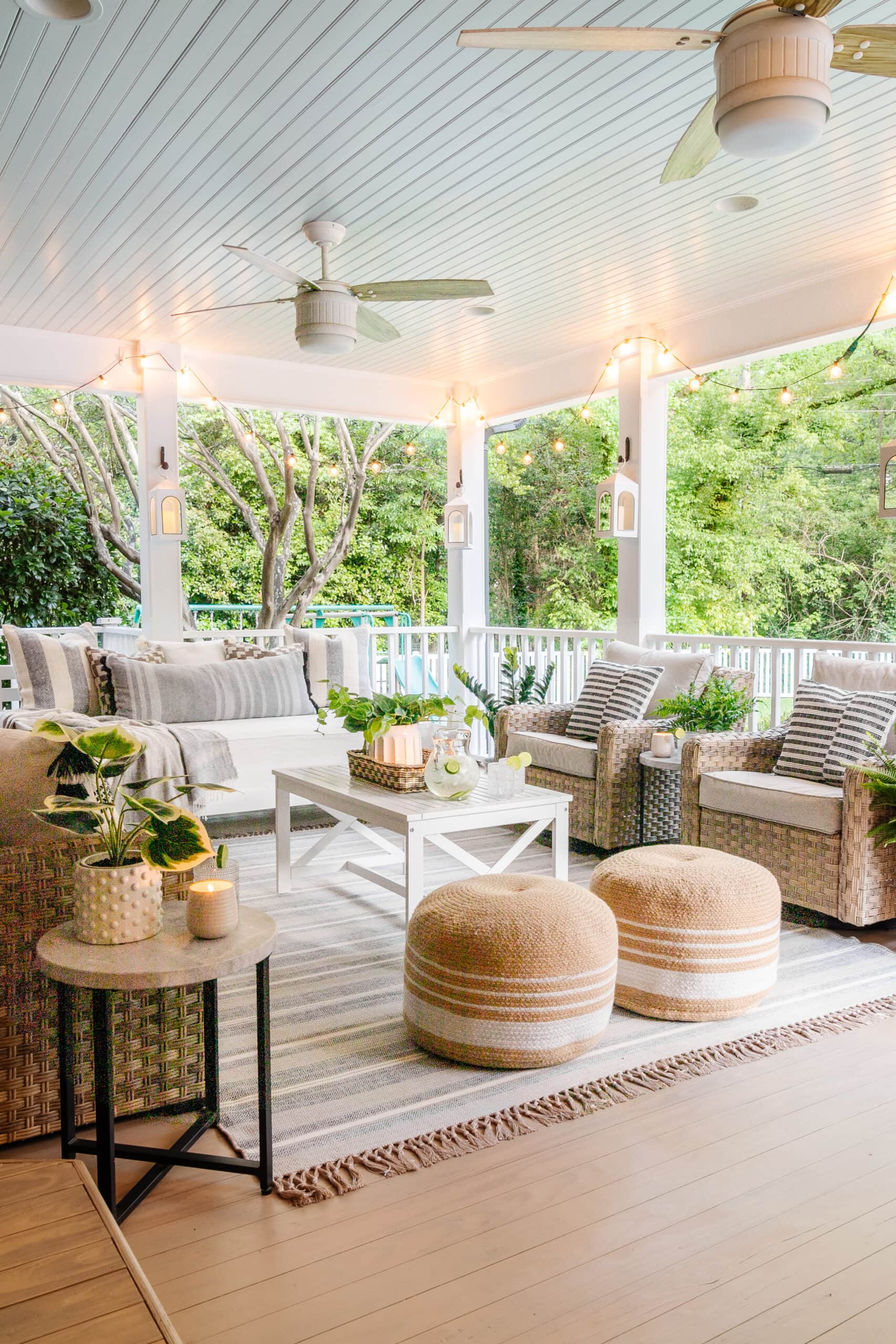 faux outdoor plants on a back porch with haint blue ceiling and wicker furniture