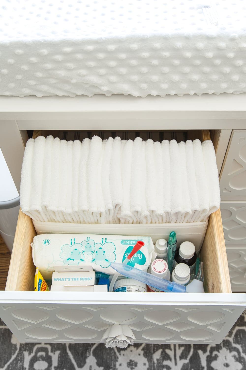 Nursery Organization | Dresser drawers with dividers to store cloth diaper liners, medicines, aspirator, thermometer, diaper cream, and wipes.