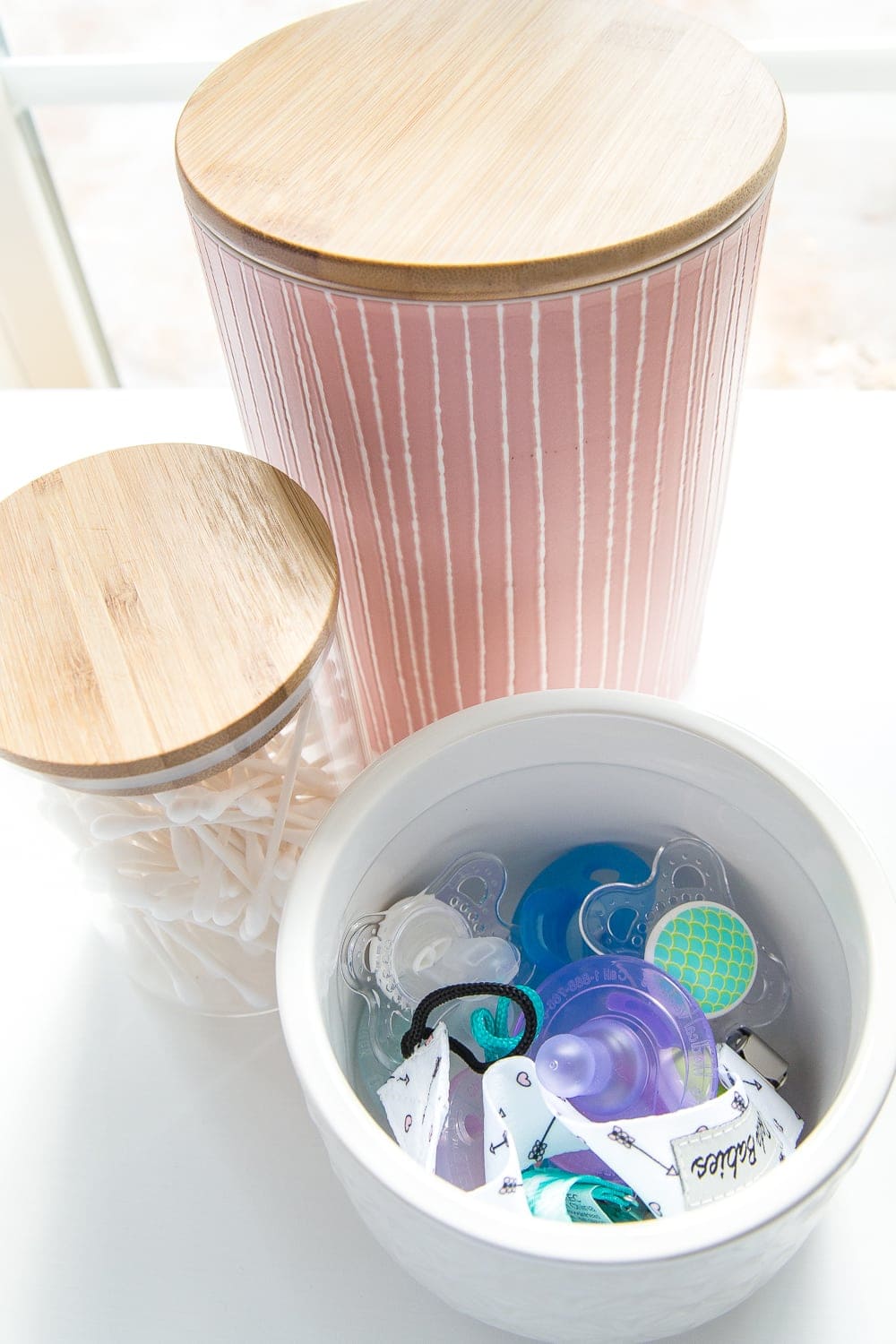 Nursery Organization | Use lidded canisters from the kitchenware aisle to store pacifiers.