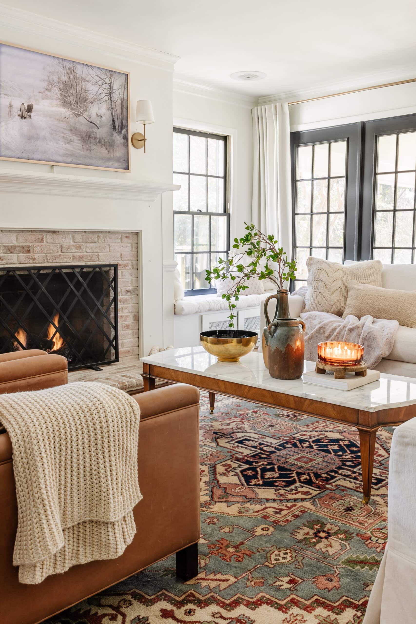 January living room winter decor with simple fireplace, snow art, and chunky blankets