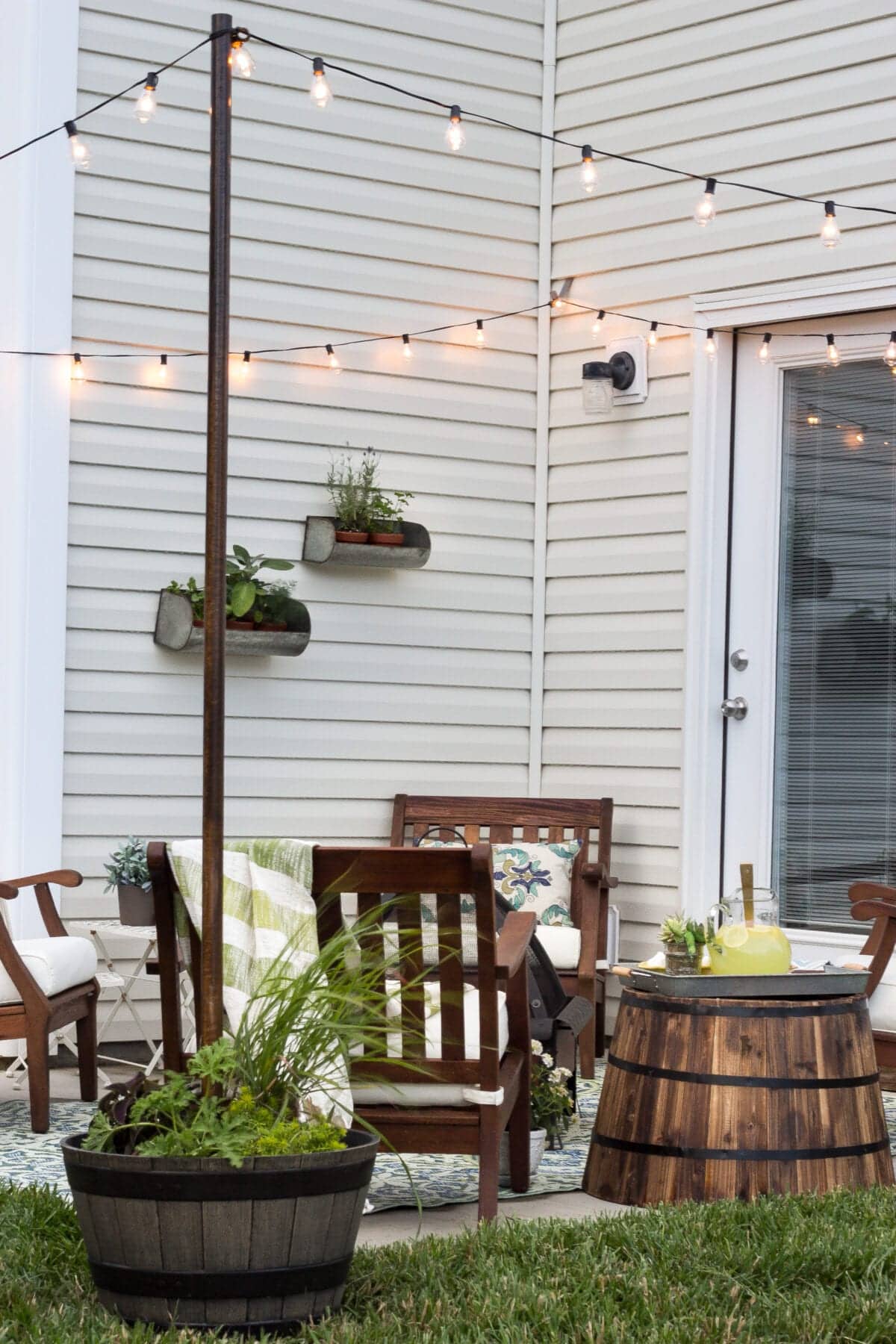 small patio makeover with DIY string light poles 